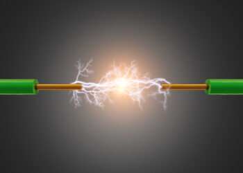 Schematyczne przedstawienie przepływu elektronów w metalowym przewodniku, symbolizujące prąd elektryczny.